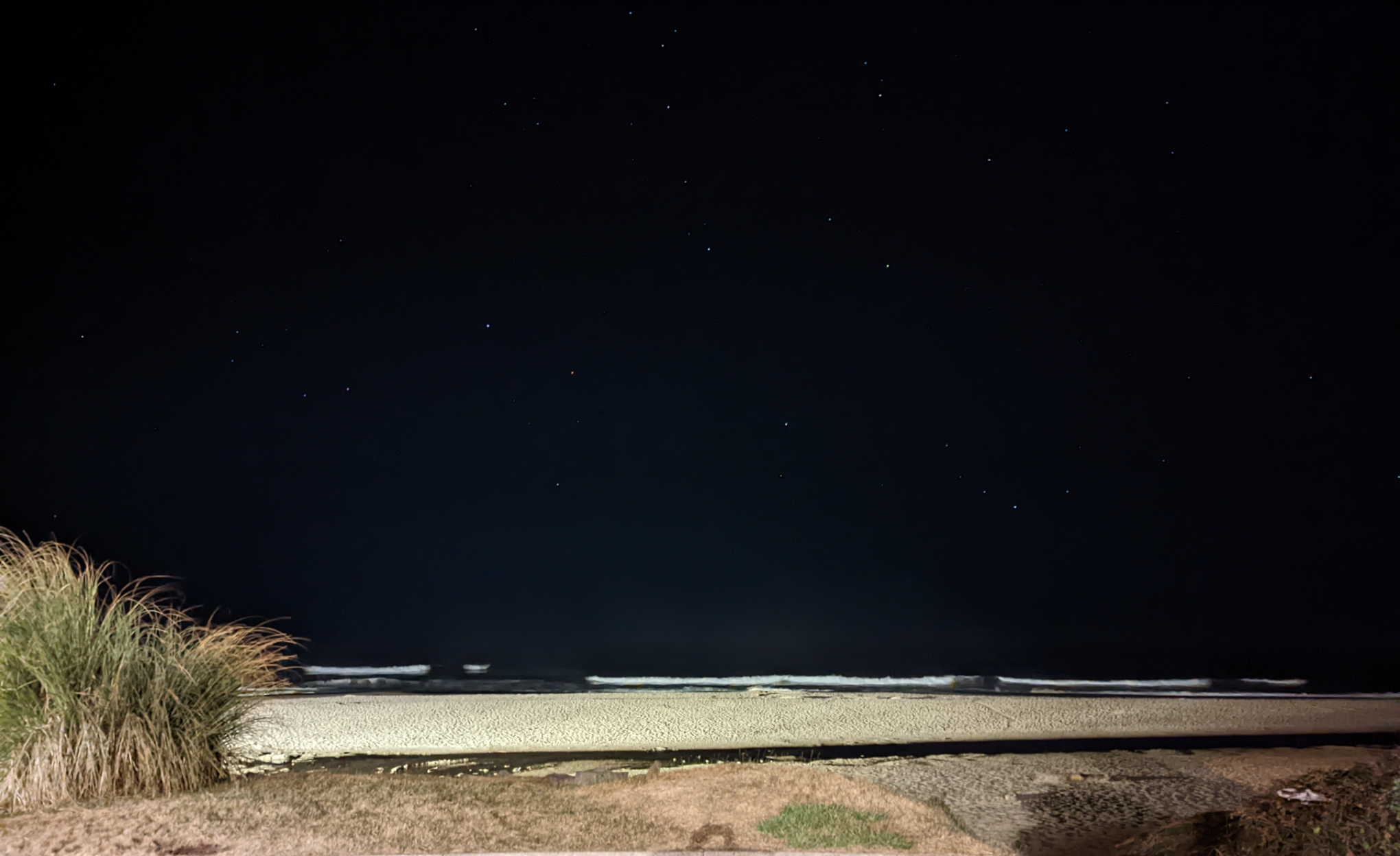Oregon Coast beach with small waves crashing and stars twinkling