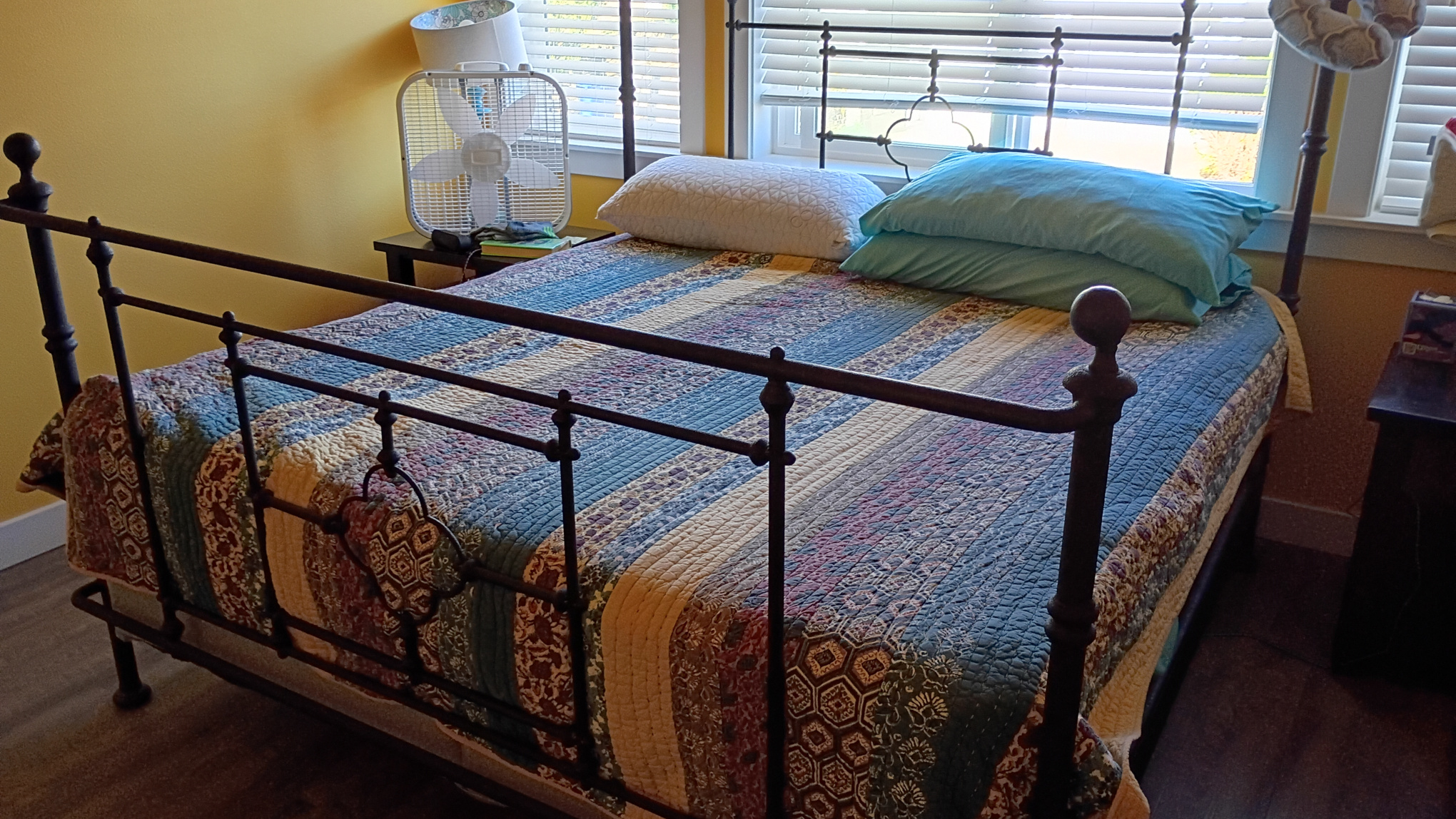 Bed cover and sheets pulled all the way up and under the pillows.