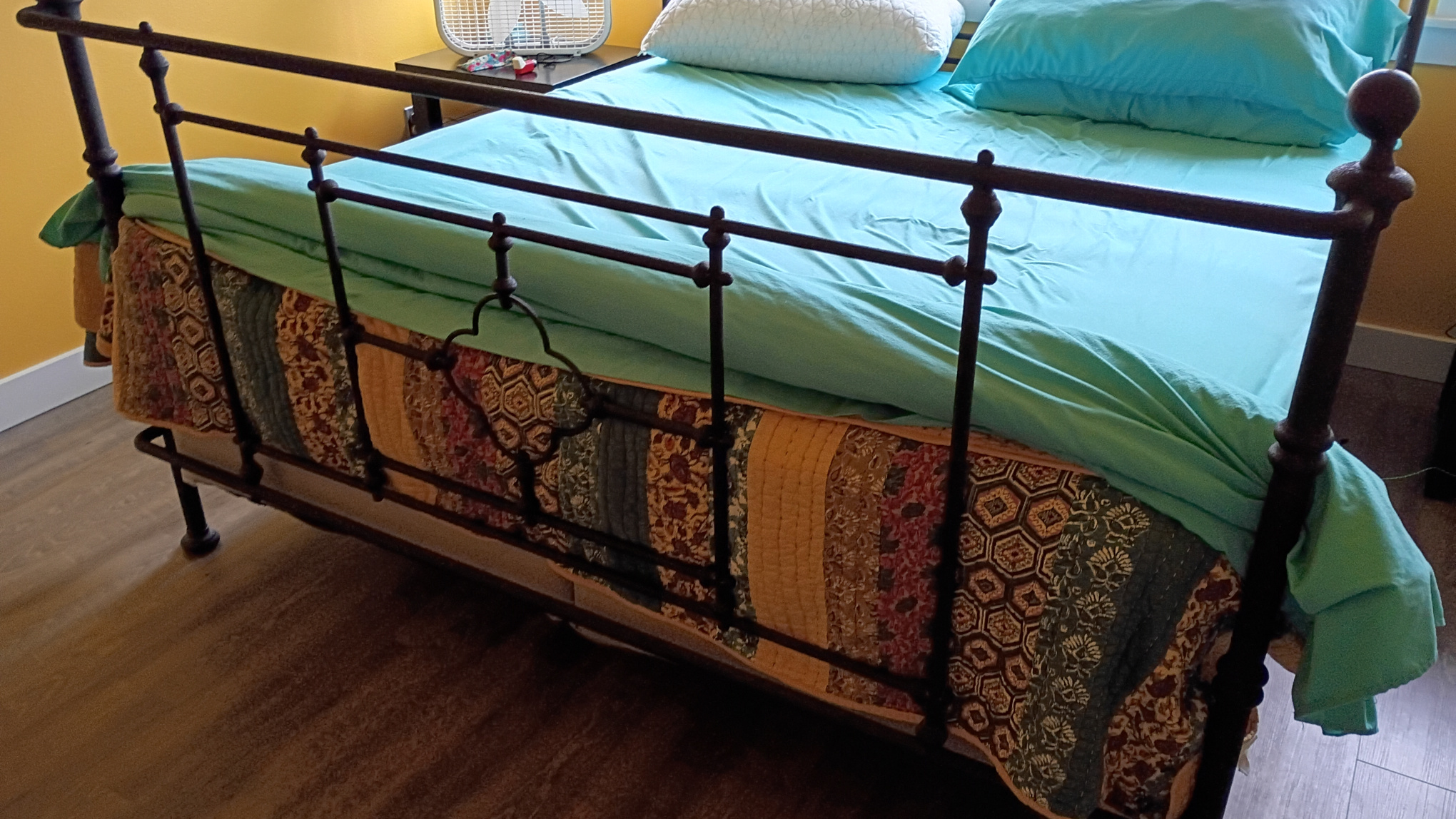 Bed cover and sheets formed into a cannoli.