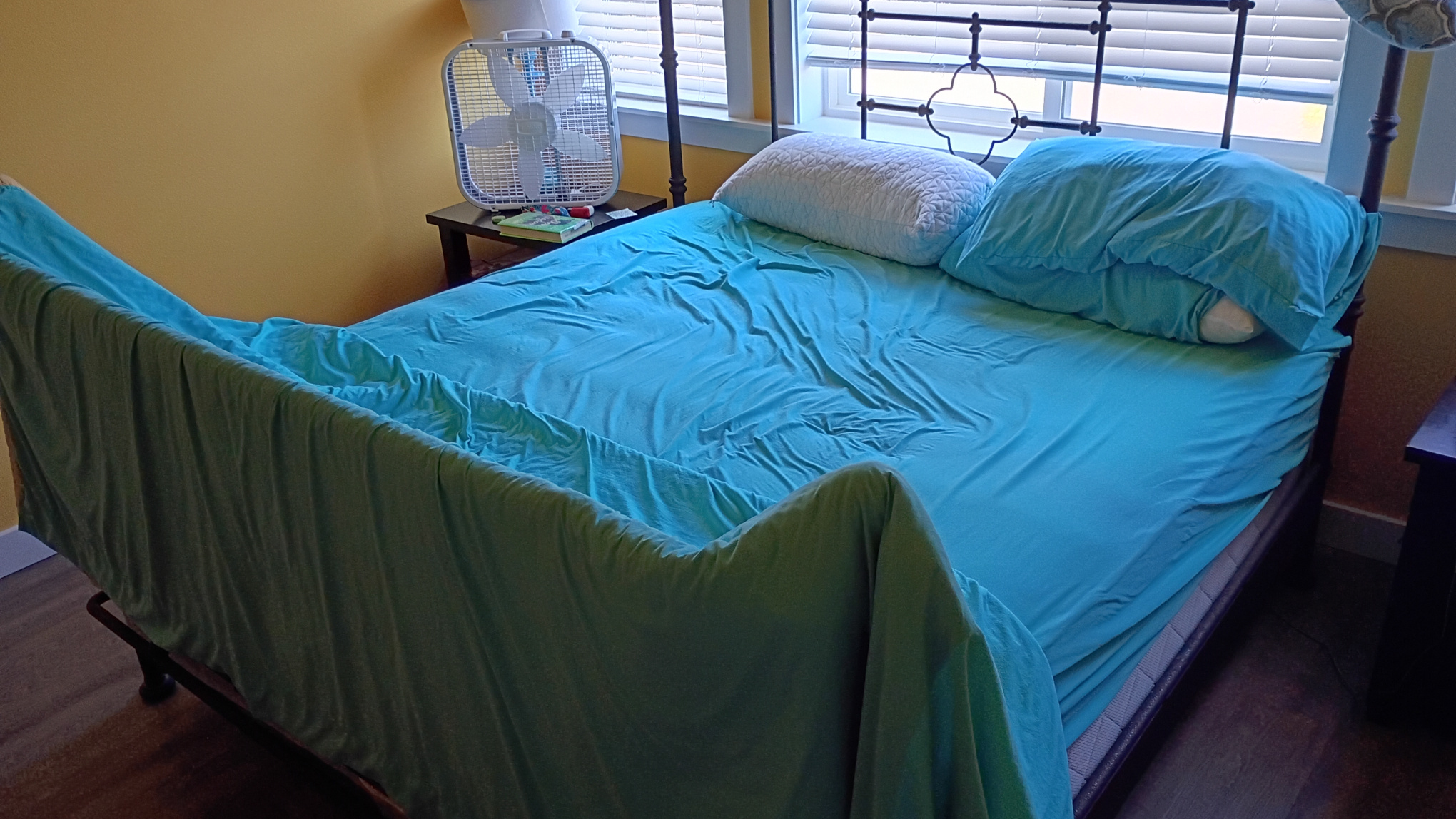 Bed cover and sheets formed into a pup tent.