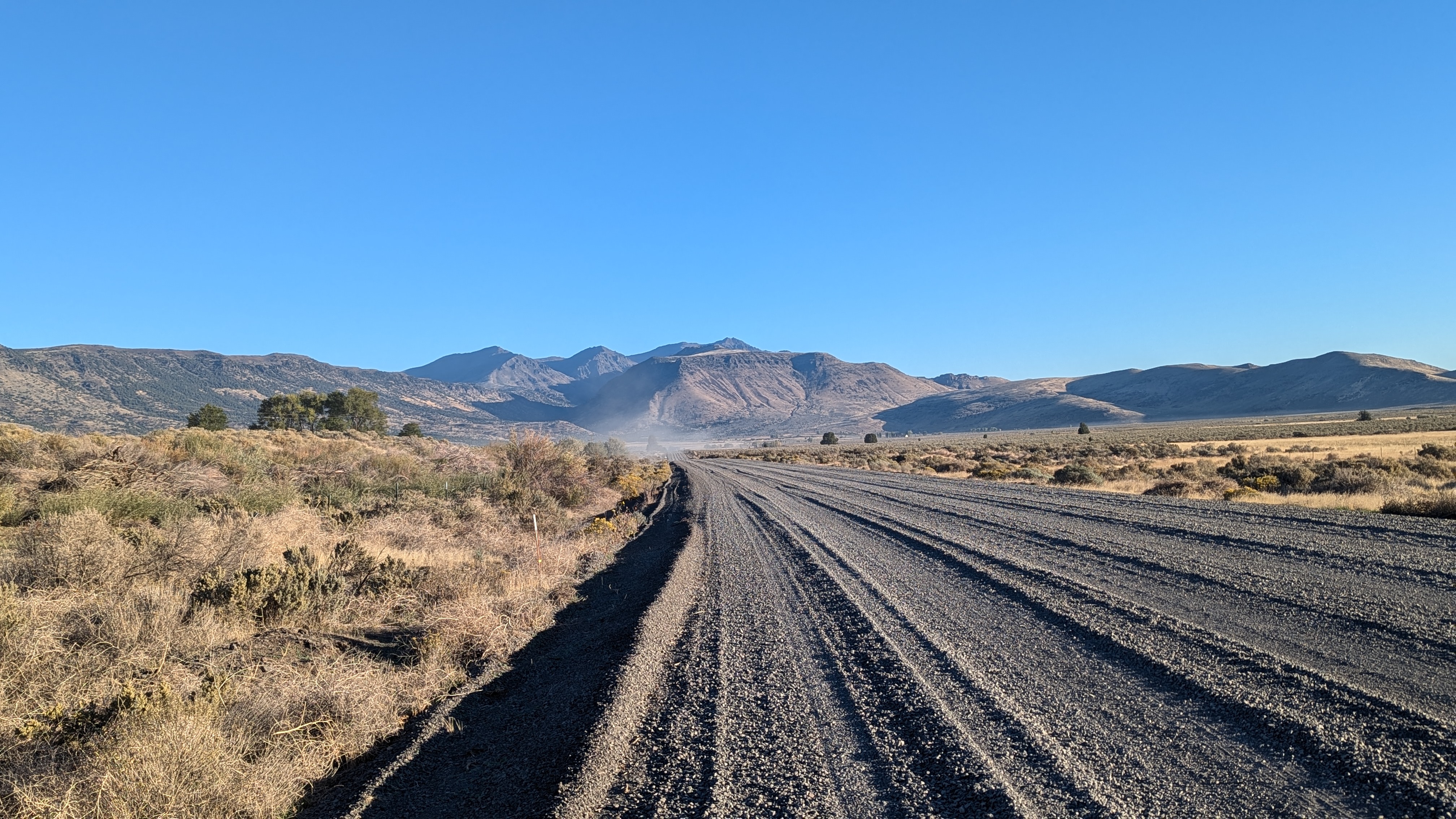 Dark gray gravel road of various depths.